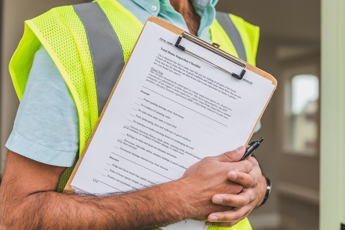 A property inspector holding a residential inspection checklist